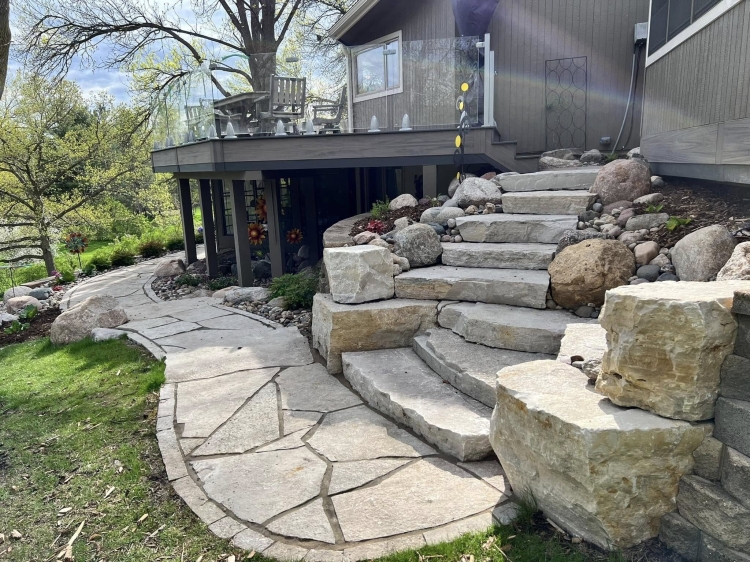 Eden stone staircase with fieldstone outcrop boulder accents