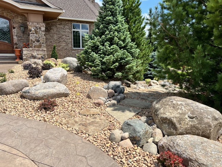Beautiful colorful planting with massive fieldstone boulder outcroppings for a grand entrance