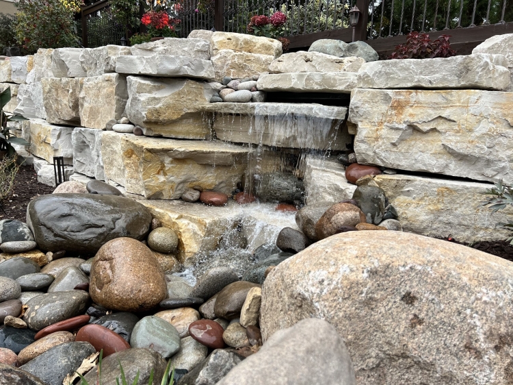 Incredible Eden stone retaining wall with build in pond-less waterfall feature.