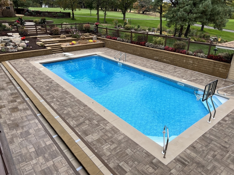 Birds eye view, large slab 6-piece paver set around pool deck and entertainment area.