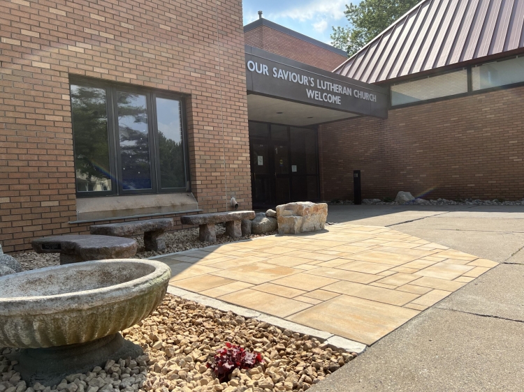 Beautiful landscape renovation for Our Saviors Luthern Church.  Project includes landscaping, planting, lawn restoration, fieldstone boulder outcroppings, and a paver patio with seating boulder and stone benches.