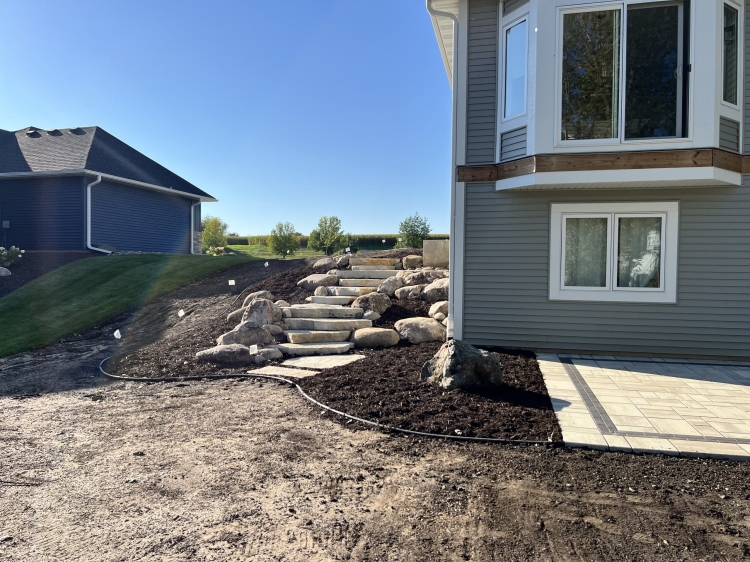 Large Eden irregular stone steps with fieldstone boulder outcroppings and Eden flagstone landing pad.