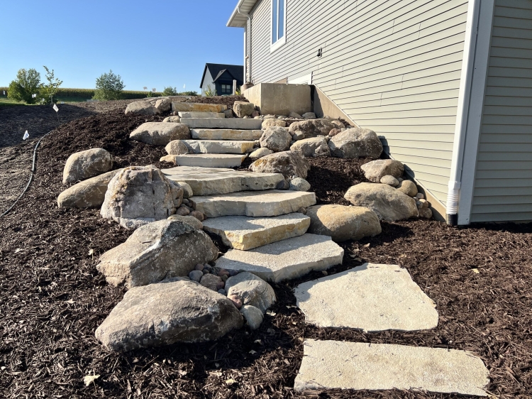 Large Eden irregular stone steps with fieldstone boulder outcroppings and Eden flagstone landing pad.
