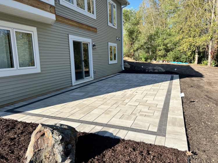 Beautiful Techo Bloc slab paver patio with charcoal inside border.
