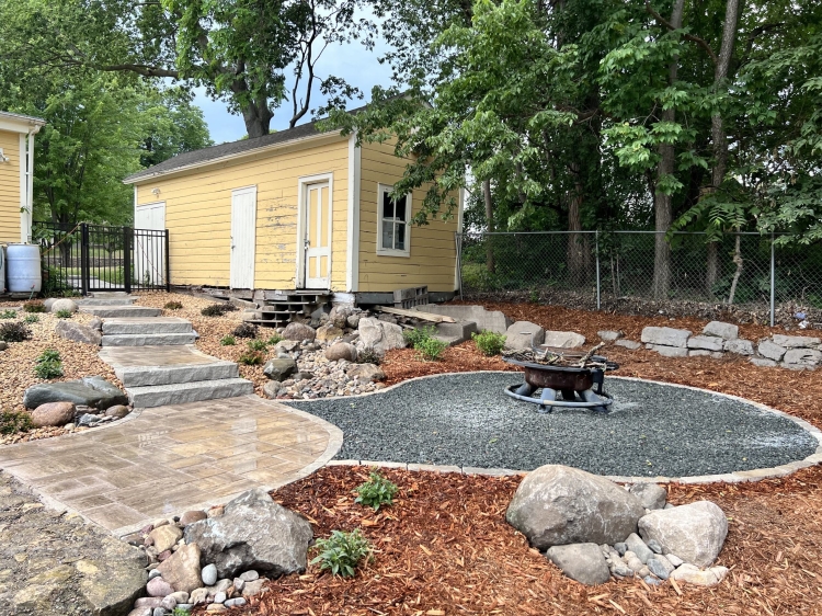 Fire pit area with gray trap rock for easy maintenance.