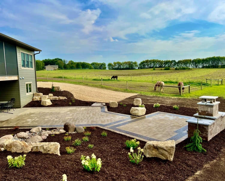 Beautiful county materials - elements paver patio with cobble paver border accent. Patio overlooks a breathtaking horse pasture and native prairie giving our customer the perfect place to enjoy everything they love in life.