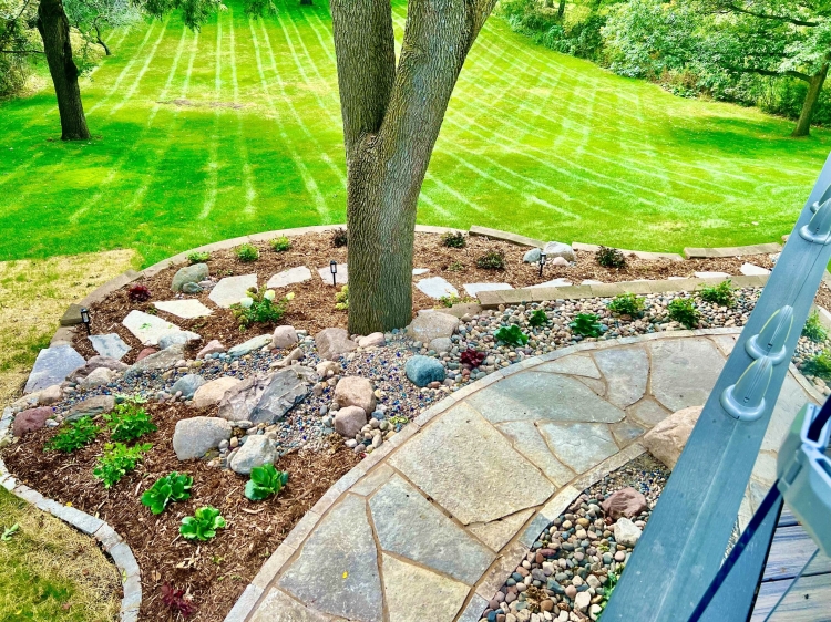 Eden flagstone stepper walkway through beautiful landscape garden.