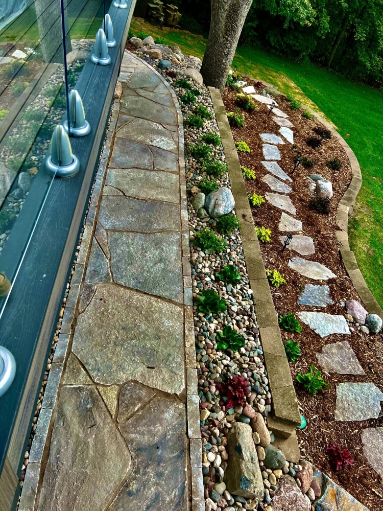 Eden flagstone stepper walkway through beautiful landscape garden.