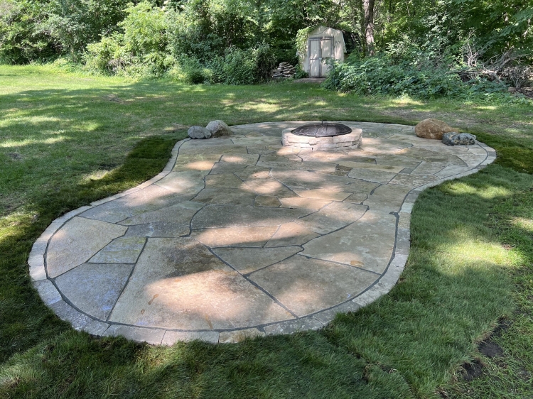Raised Eden stone firepit built into Eden flagstone patio