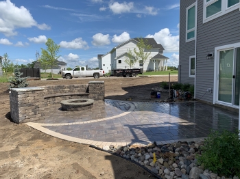 Paver patio with raised firepit and seating wall