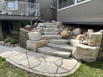 Eden stone steps with fieldstone boulder outcrop accents which was built into existing block wall.