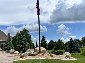 Dramatic entrance with colorful plantings and massive fieldstone boulder outcroppings