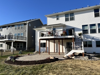Large paver patio giving customers room for hot tub and entertainment area overlooking the backyard pond.