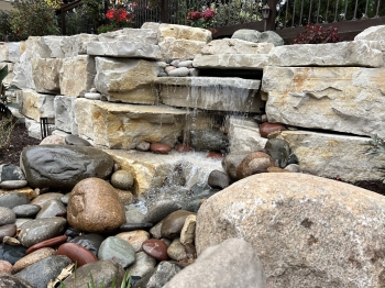 Incredible Eden stone retaining wall with build in pond-less waterfall feature. 
