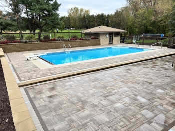 Large slab paver patio around pool and entertainment area.