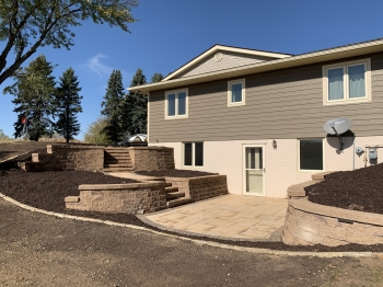 Block retaining walls with steps and paver patio/walkways