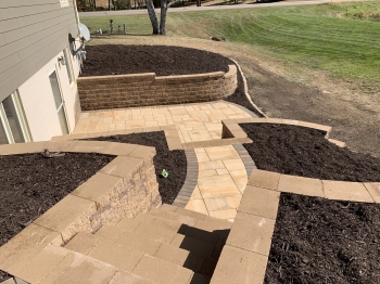 Block retaining walls with steps and paver patio/walkways
