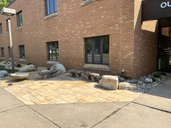 Beautiful landscape renovation for Our Saviors Luthern Church.  Project includes landscaping, planting, lawn restoration, fieldstone boulder outcroppings, and a paver patio with seating boulder and stone benches. 