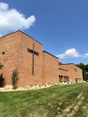 Beautiful landscape renovation for Our Saviors Luthern Church.  Project includes landscaping, planting, lawn restoration, fieldstone boulder outcroppings, and a paver patio with seating boulder and stone benches. 