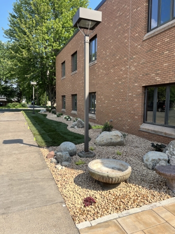 Beautiful landscape renovation for Our Saviors Luthern Church.  Project includes landscaping, planting, lawn restoration, fieldstone boulder outcroppings, and a paver patio with seating boulder and stone benches. 