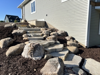 Large Eden irregular stone steps with fieldstone boulder outcroppings and Eden flagstone landing pad.