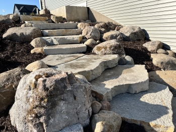Large Eden irregular stone steps with fieldstone boulder outcroppings and Eden flagstone landing pad.