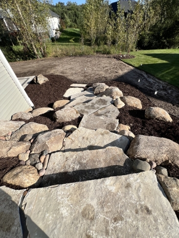 Large Eden irregular stone steps with fieldstone boulder outcroppings and Eden flagstone landing pad.