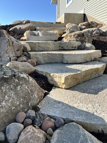Large Eden irregular stone steps with fieldstone boulder outcroppings and Eden flagstone landing pad.
