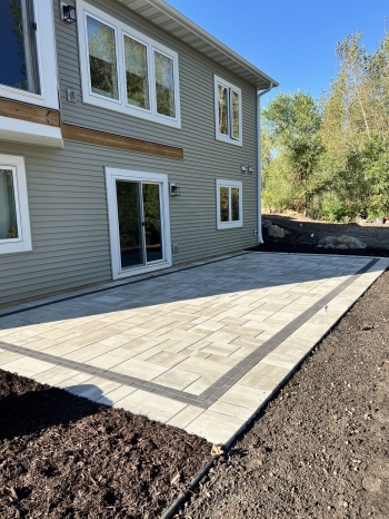 Beautiful Techo Bloc slab paver patio with charcoal inside border. 