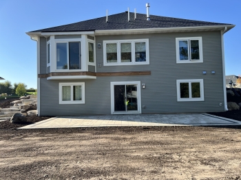 Beautiful Techo Bloc slab paver patio with charcoal inside border. 