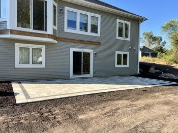 Beautiful Techo Bloc slab paver patio with charcoal inside border. 