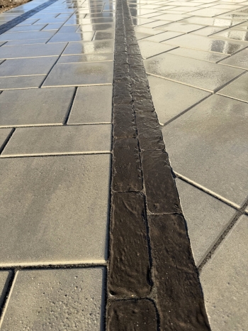 Techo bloc 3-Piece slab paver set with textured charcoal border. 