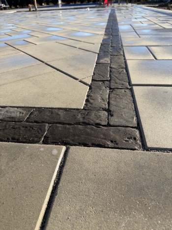 Techo bloc 3-Piece slab paver set with textured charcoal border. 