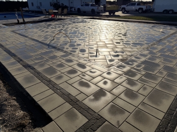 Techo bloc 3-Piece slab paver set with textured charcoal border. 