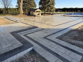 Techo bloc 3-Piece slab paver set with textured charcoal border. 