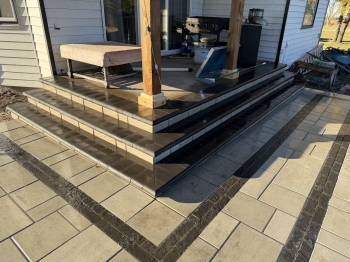 County materials block with charcoal bullnose treads to tie into paver patio design.