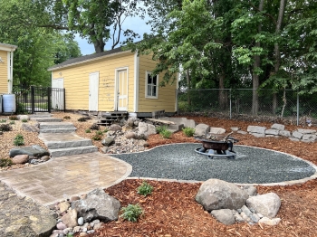 Fire pit area with gray trap rock for easy maintenance. 