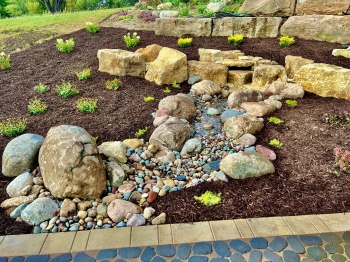 Beautiful county materials - elements paver patio with cobble paver border accent. Patio overlooks a breathtaking horse pasture and native prairie giving our customer the perfect place to enjoy everything they love in life.