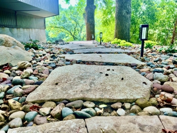 Large chilton flagstone stepper walkway through landscape garden.