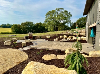 Beautiful landscaping beds around patio area overlooking horse pasture and native field. 